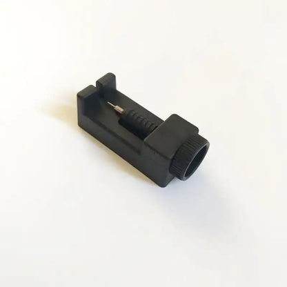 Black plastic component on a white background