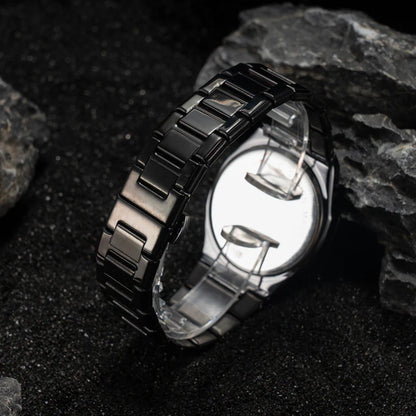 Black ceramic watch on a dark stone surface