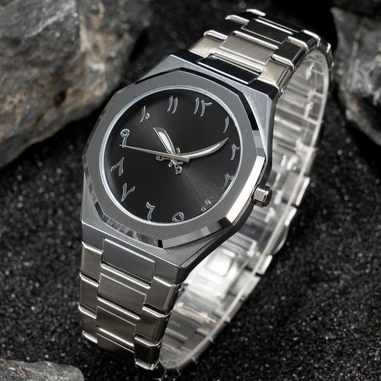 Silver watch with black face on a dark textured background