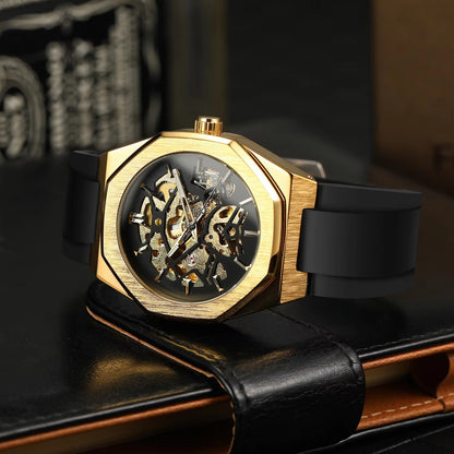 Gold wristwatch with black strap on a dark surface