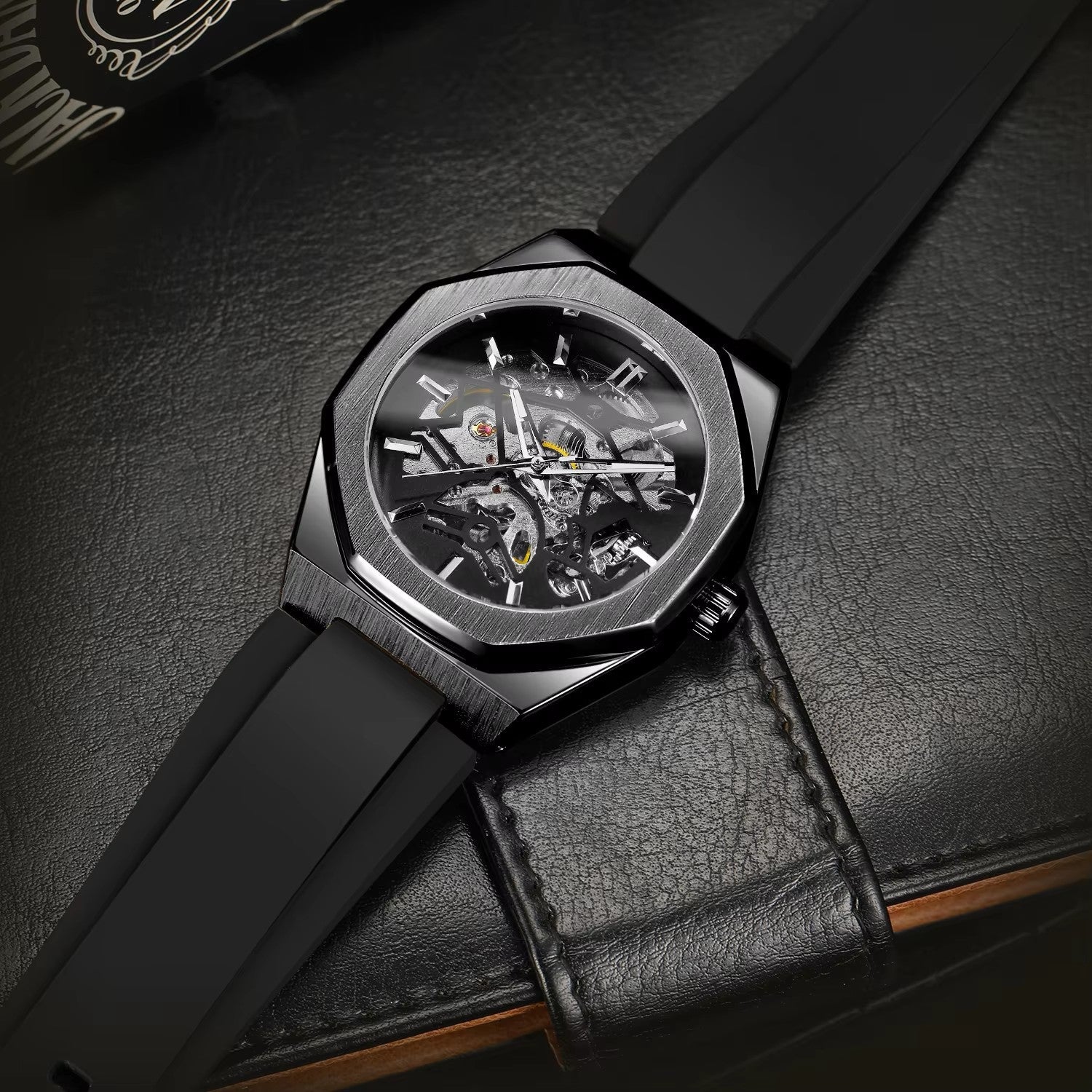 Black wristwatch with detailed mechanism on a dark textured surface