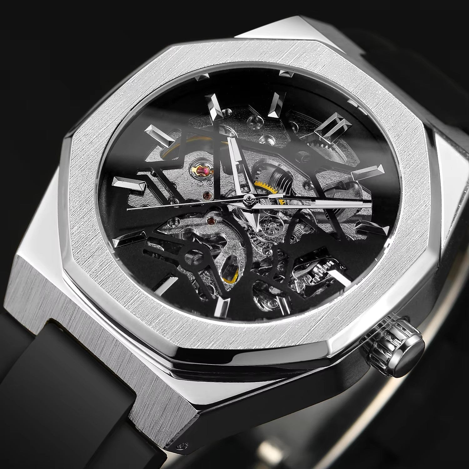 Silver wristwatch with transparent face showing mechanical components on a black background