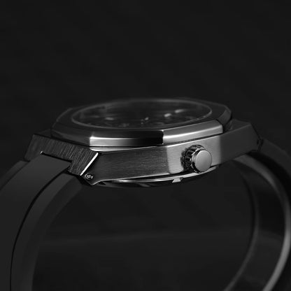 Close-up of a silver watch on a black background