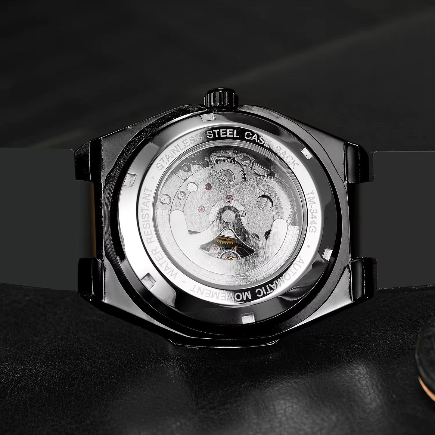Mechanical watch back cover with visible movement on a dark background